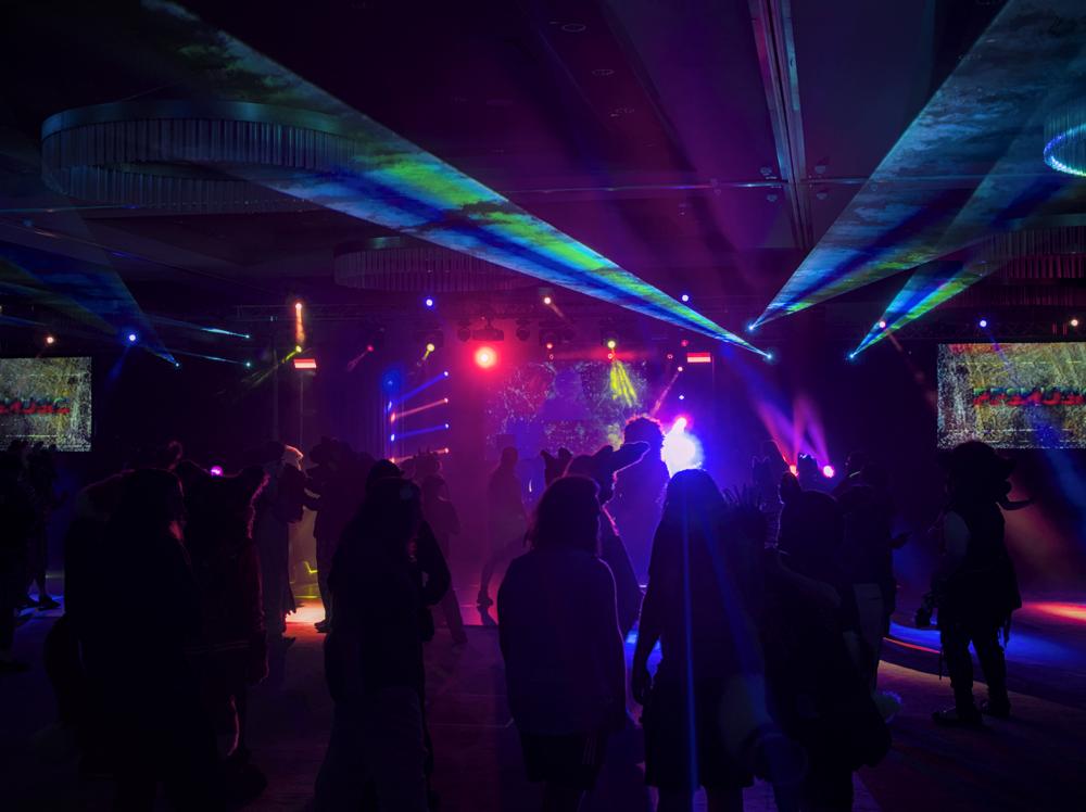 A rave in a dark room. There's lots of stage lights and lasers
